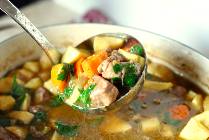 TheInspiredHome.org // Beer Braised Pork Stew Recipe with Apples and Root Vegetables being spooned by a ladle